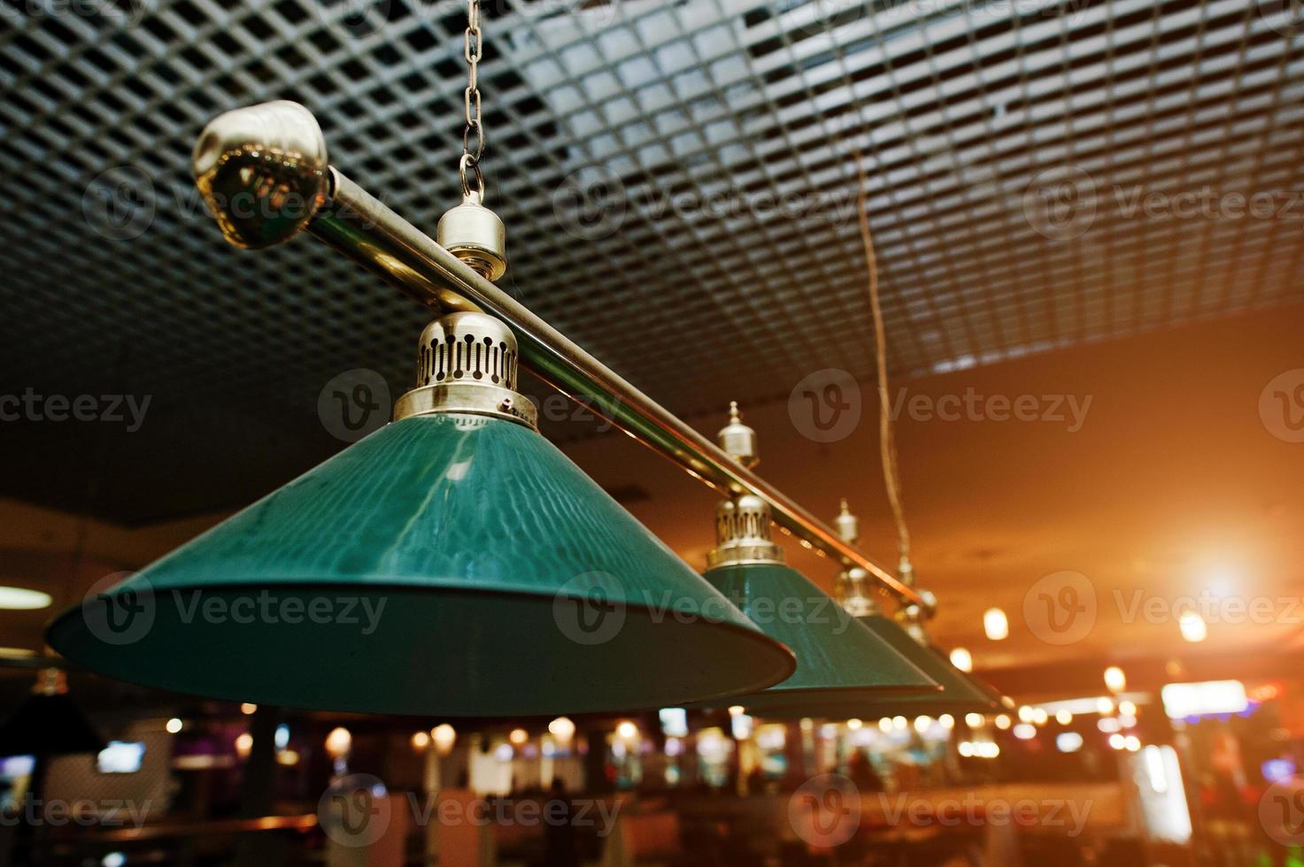 Close up of billiard lamps over pool photo