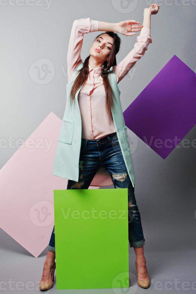 Full length of beautiful girl, with green blank advertising board , over gray background and pink and violet banner . Your text here. Concept art photo