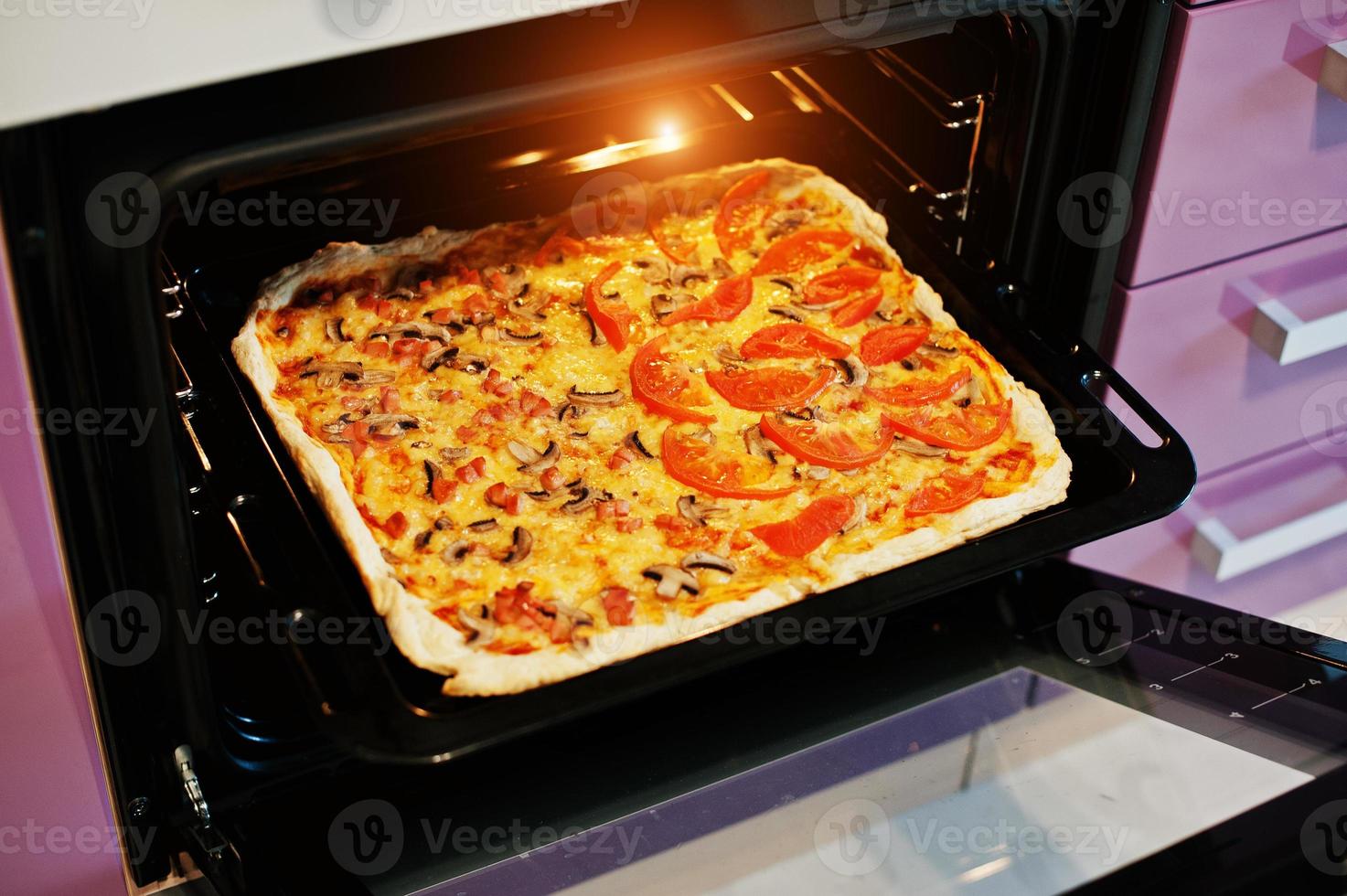 Homemade pizza in electric oven in the kitchen 5971058 Stock Photo at