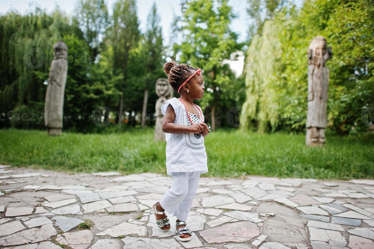 Close up portrait of african baby girl walking at park photo