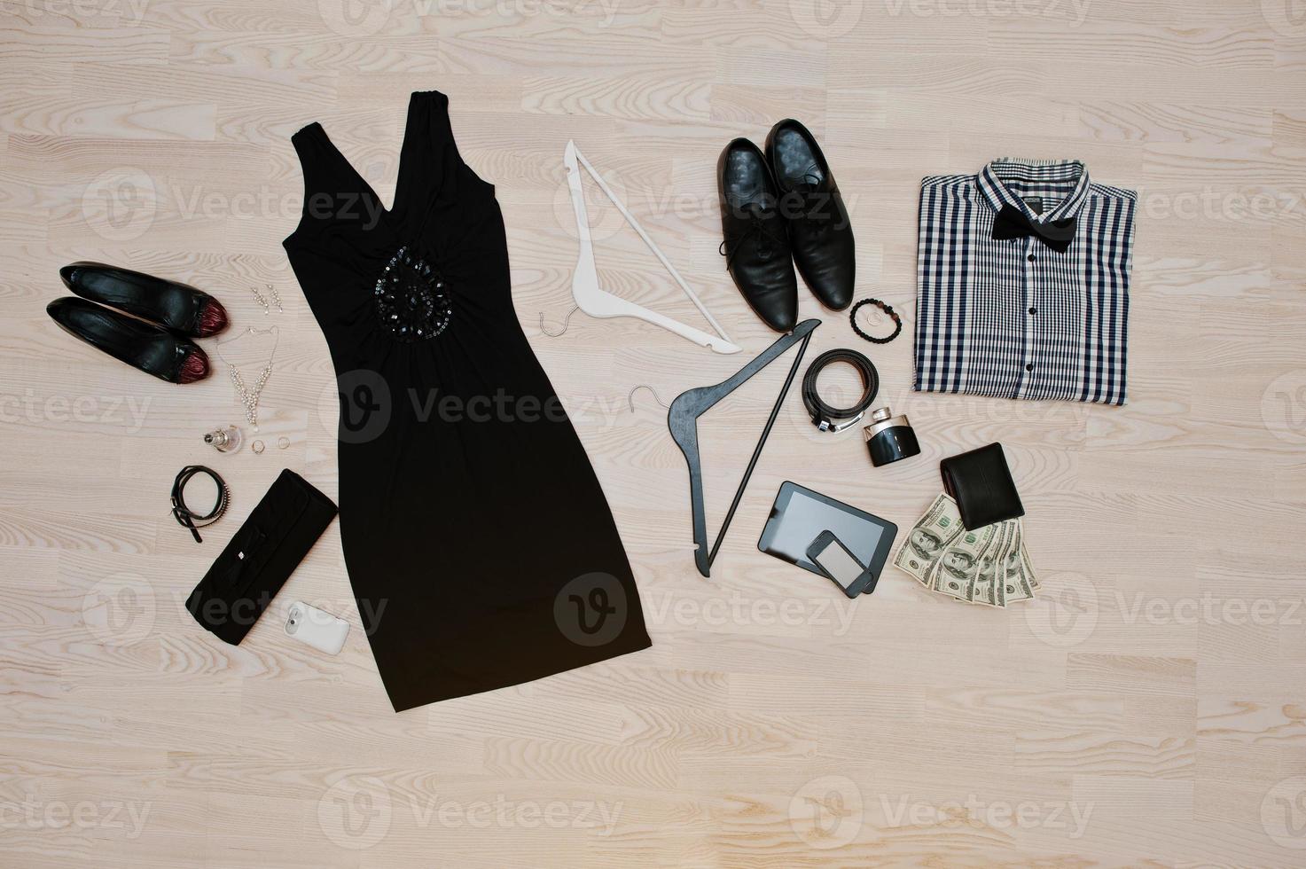 Set of trendy clothes. Outfit of man and woman clothes and accessories on light wooden background photo