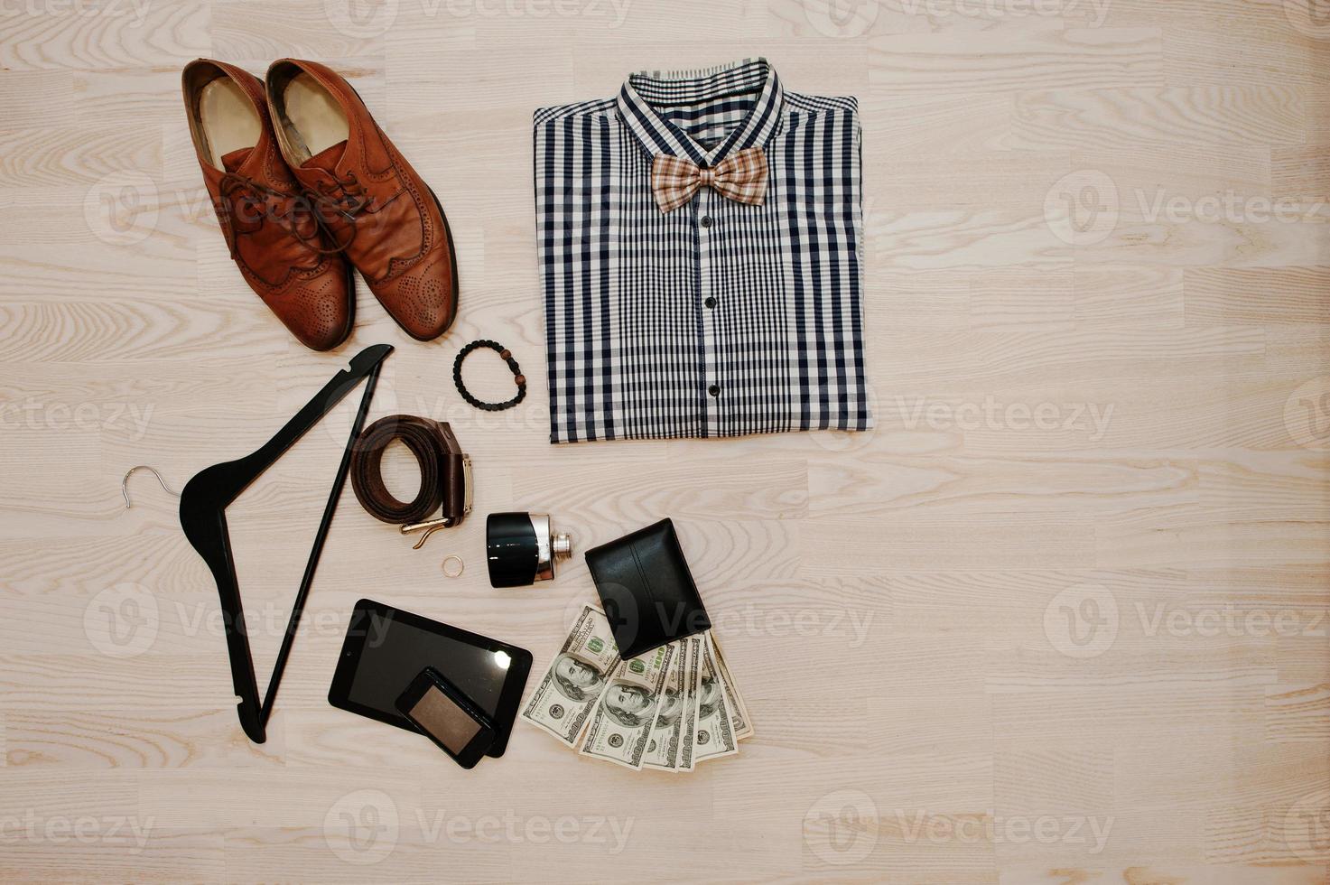 Men's casual outfits with accessories on light wooden background photo