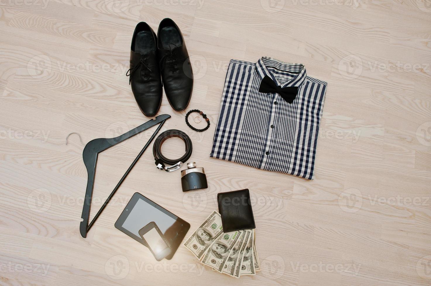 Men's casual outfits with accessories on light wooden background photo