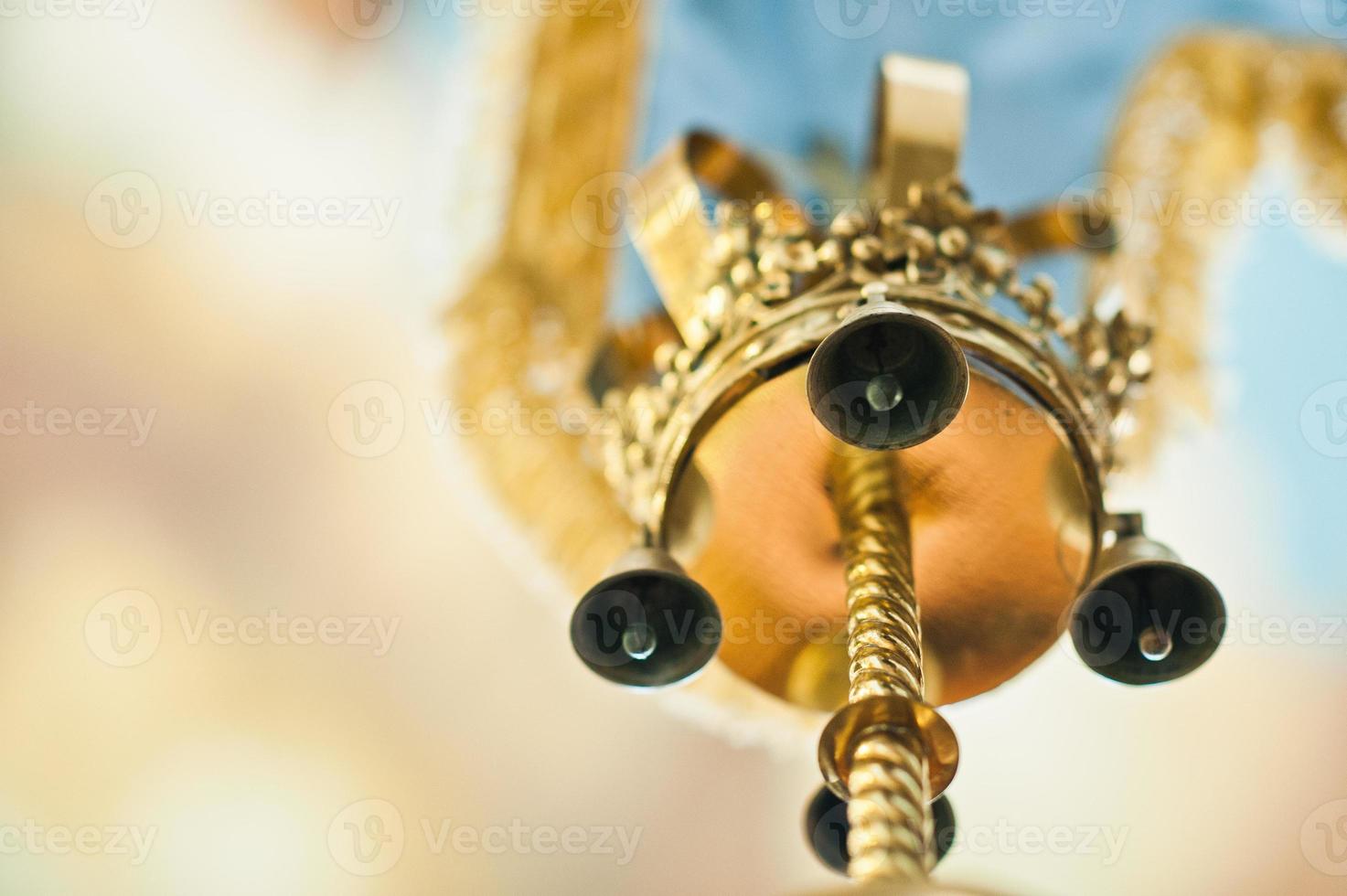 Small bells at gonfalon with golden crown at church photo