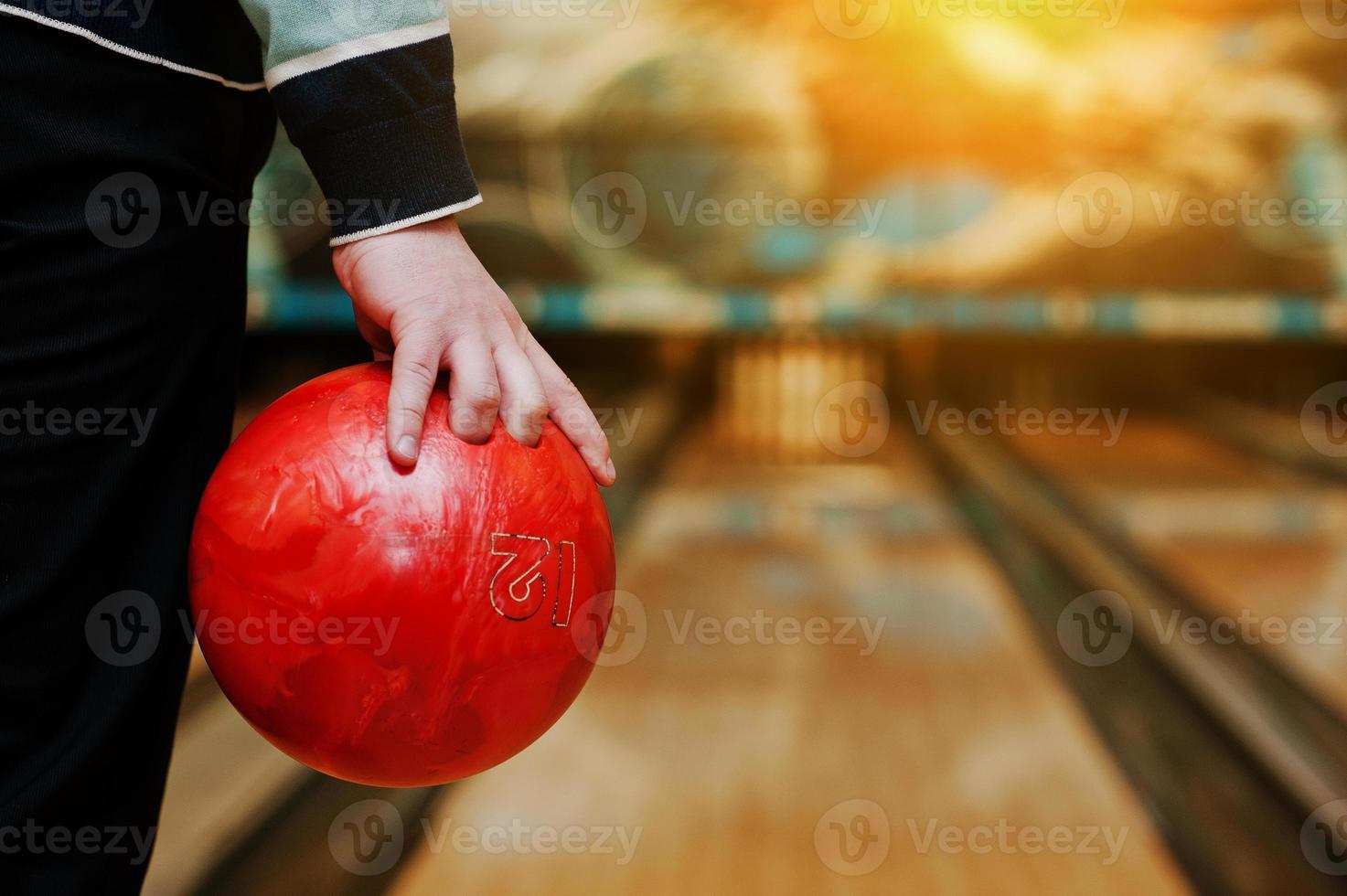 Bowling ball at hand of man background bowling alley photo