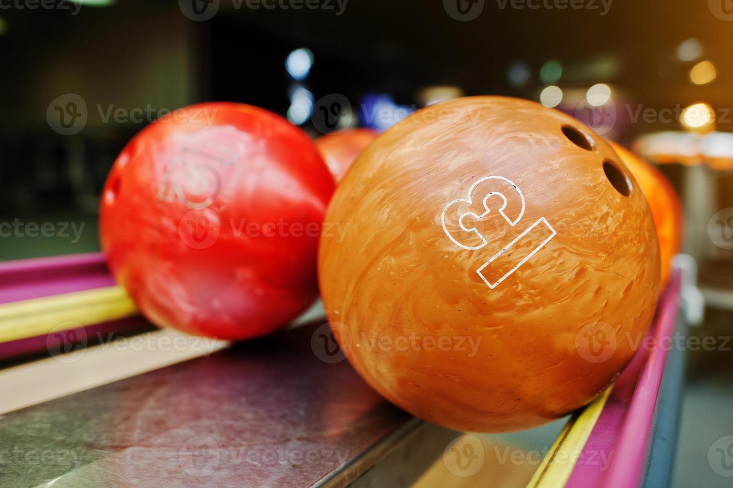 Two colored bowling balls of number 13 and 12 photo