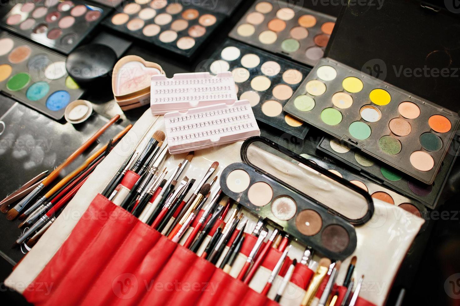 Set of professional makeup brush and colorful eye shadows palette. photo