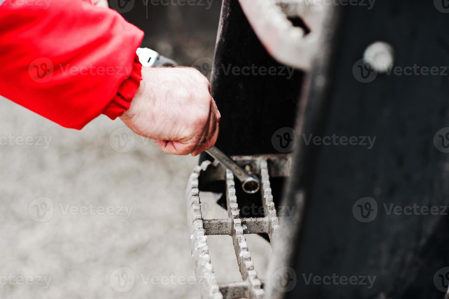 Mechanic hand hold spanner tool in hand at work photo