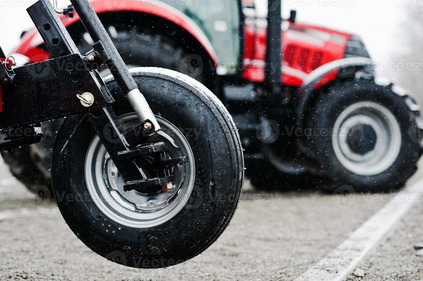 Wheel of new red agricultural seeder close up view photo