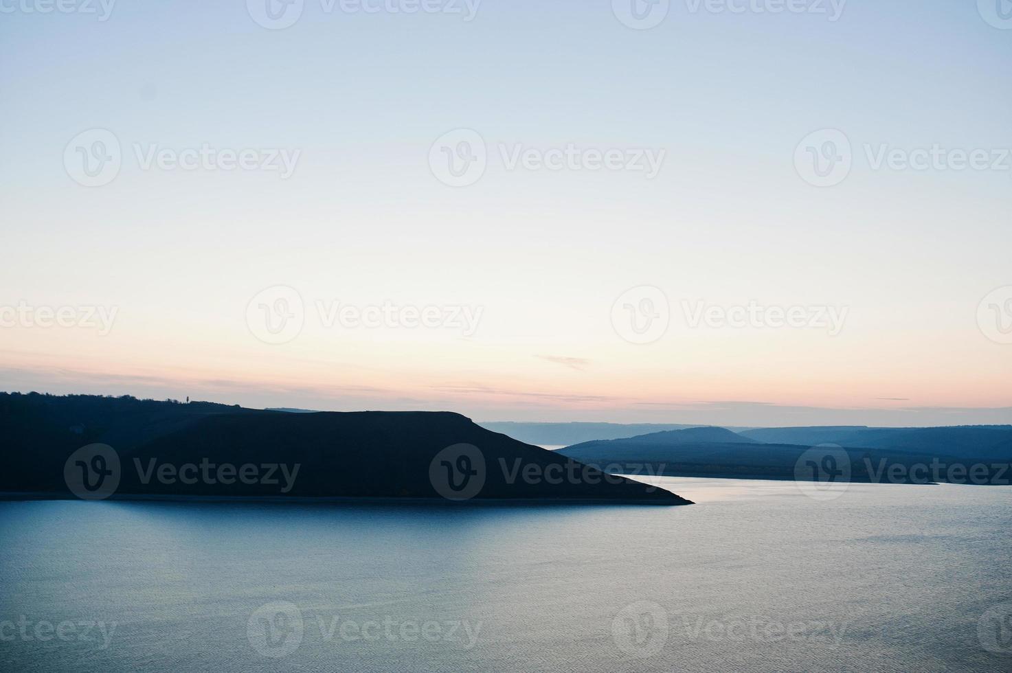 Extraordinary sunset on a background of mountains and river photo