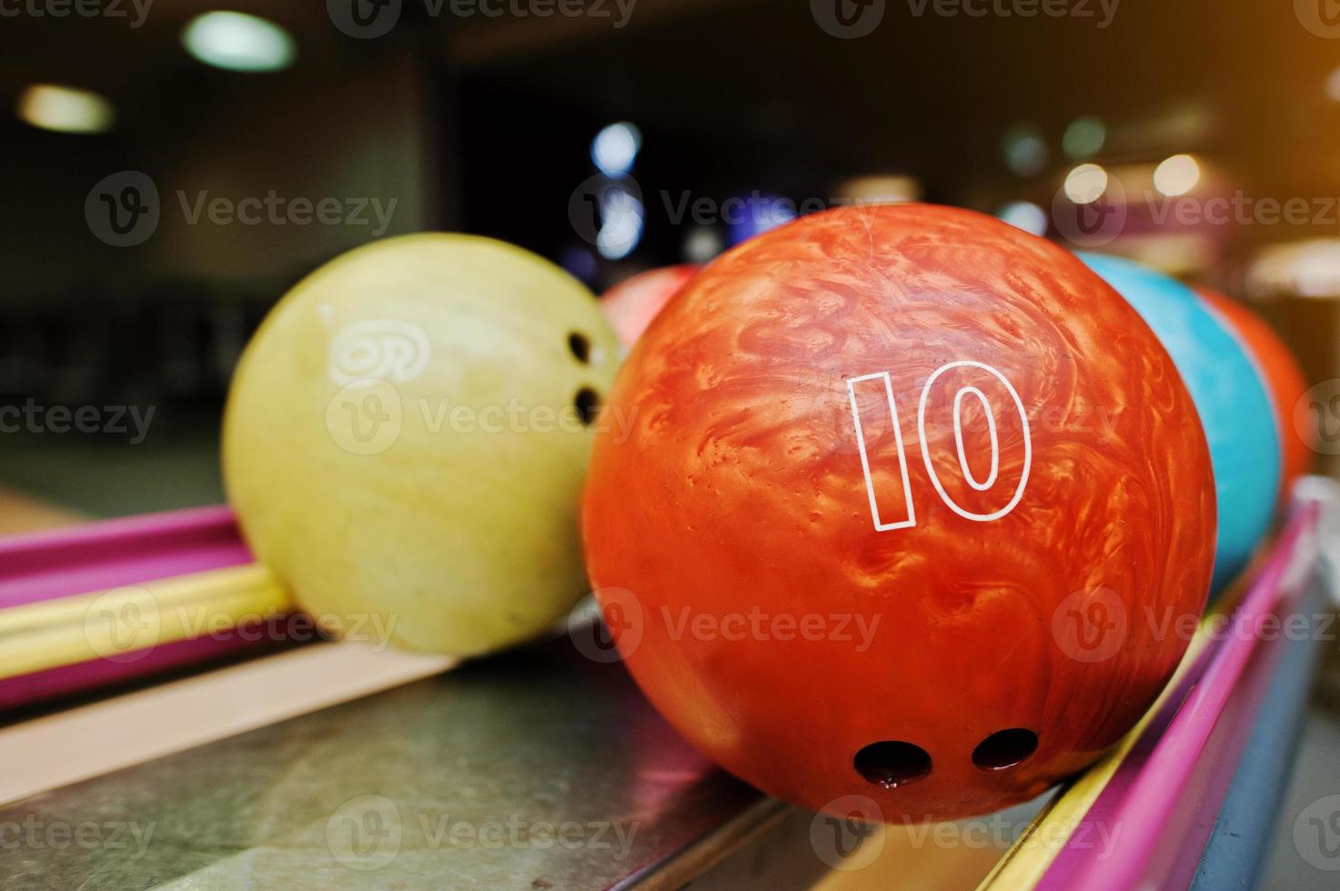 Two colored bowling balls of number 10 and 9 photo