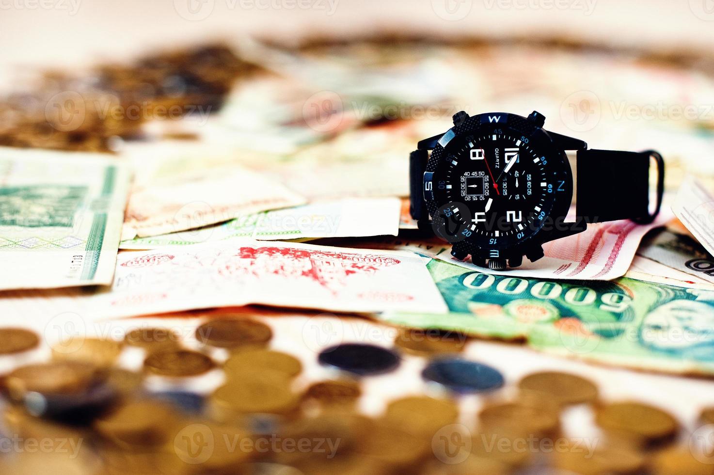 Black watch on money. Time is money concept photo