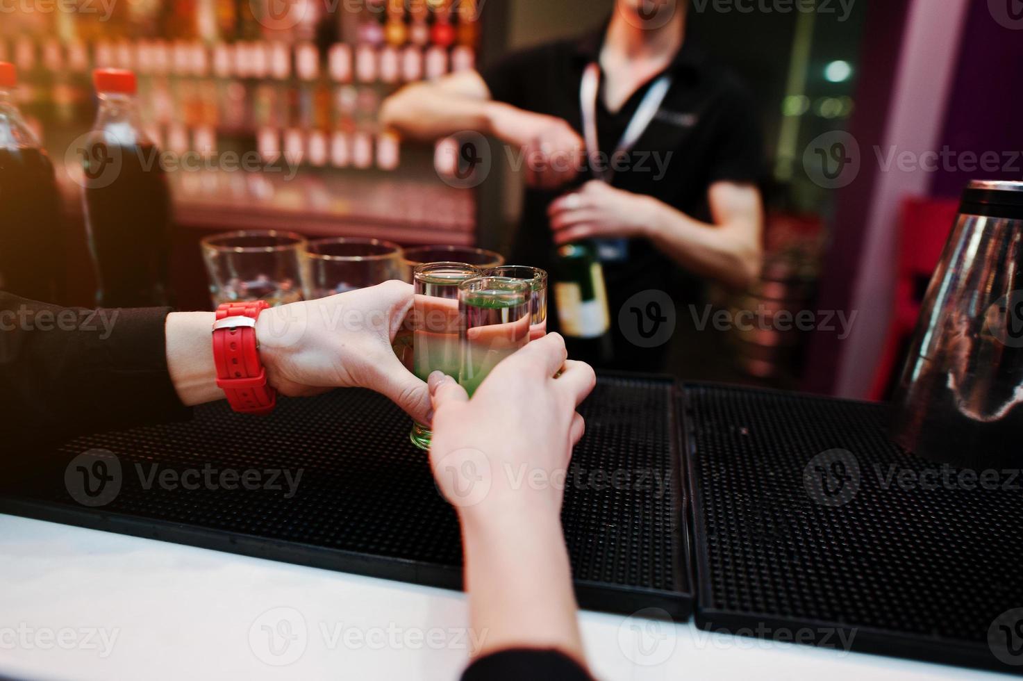 Waiter hands holding green mexican tequila coctails drink background bar man at work photo