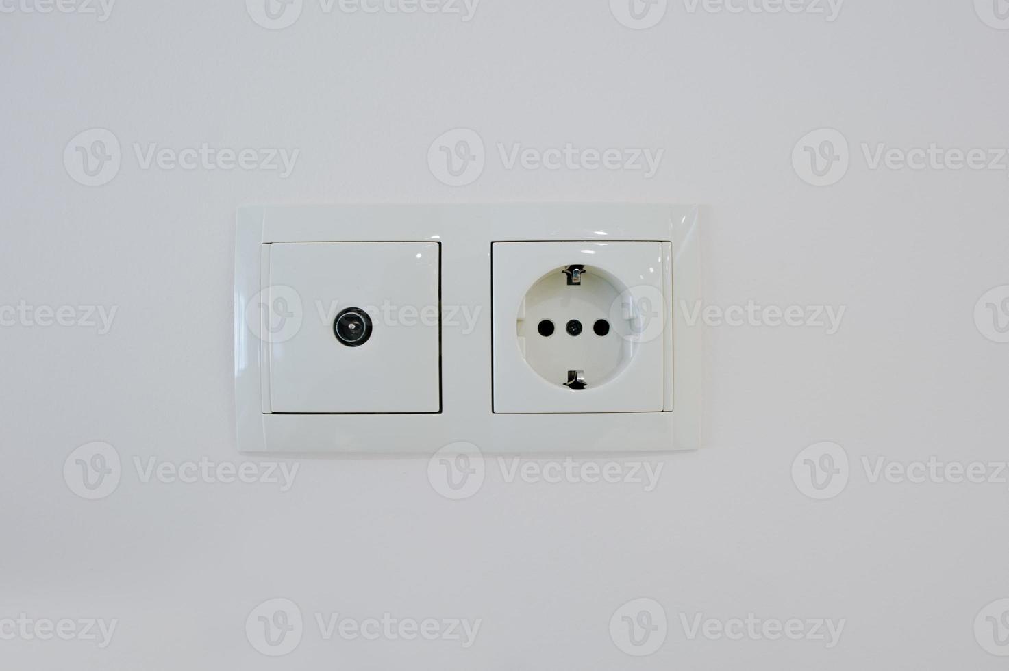 Twin electric socket with tv plug at the wall photo
