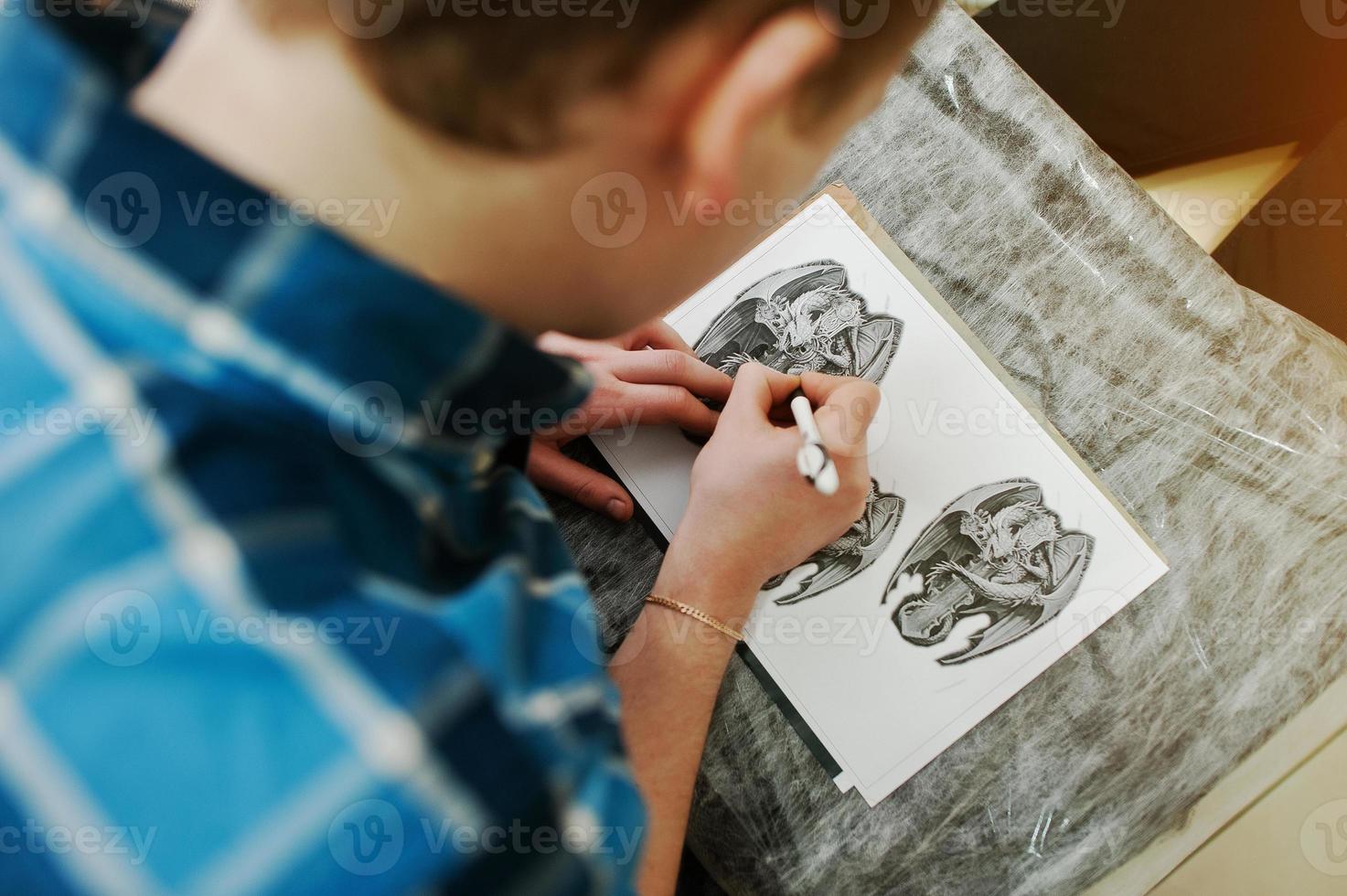 Tattoo master preparing sketch for tattoo photo