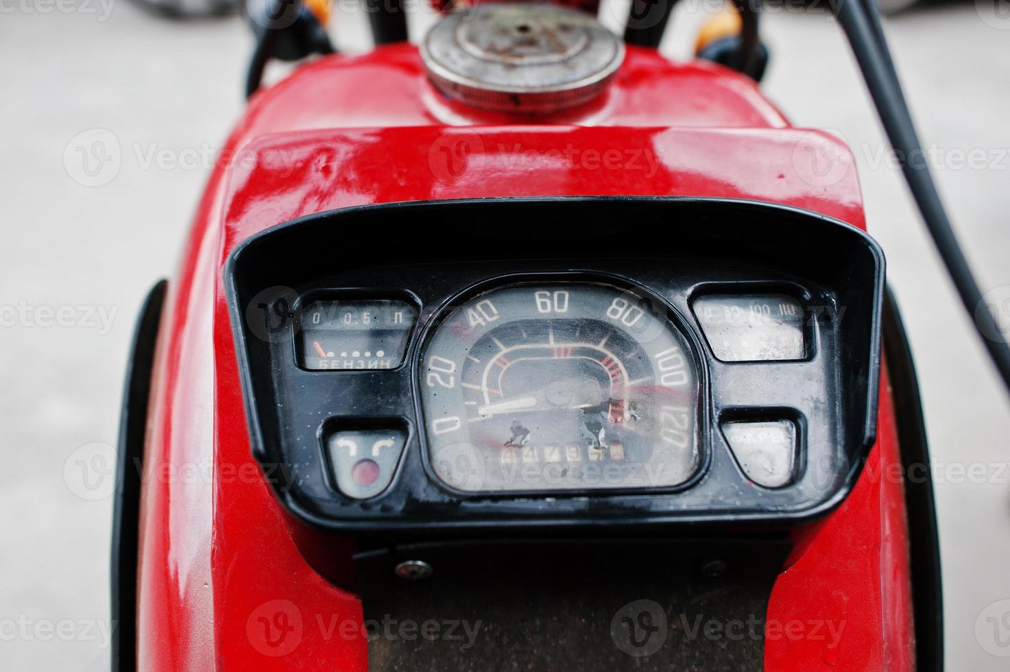 Old motorcycle speedometer. Close up of the dashboard at red cycle. photo