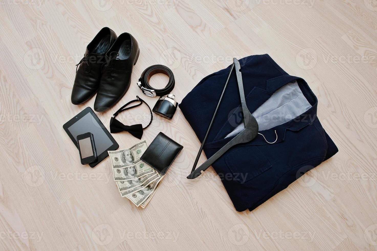 Men's casual outfits with accessories on light wooden background photo