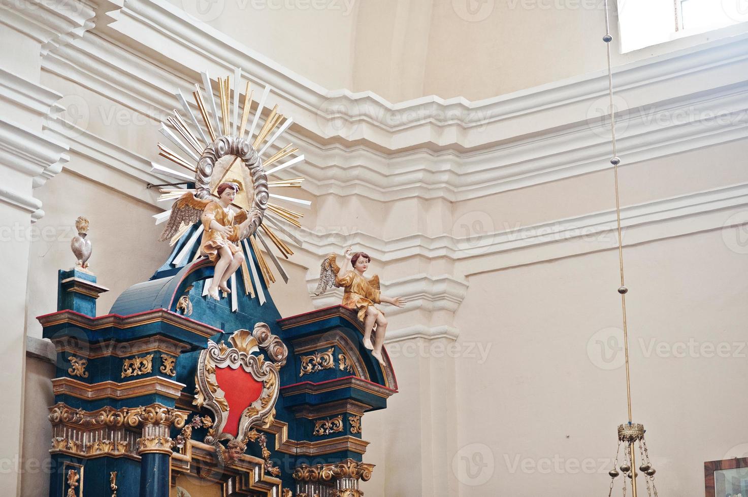 Eye in the triangle and figure of angels at iconostasis on church photo