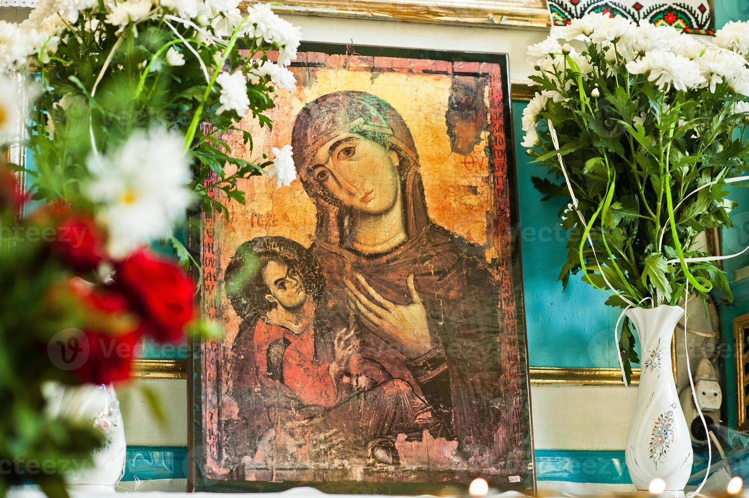 Old wooden image icon of the Mother of God Mary and child Jesus Christ at church photo