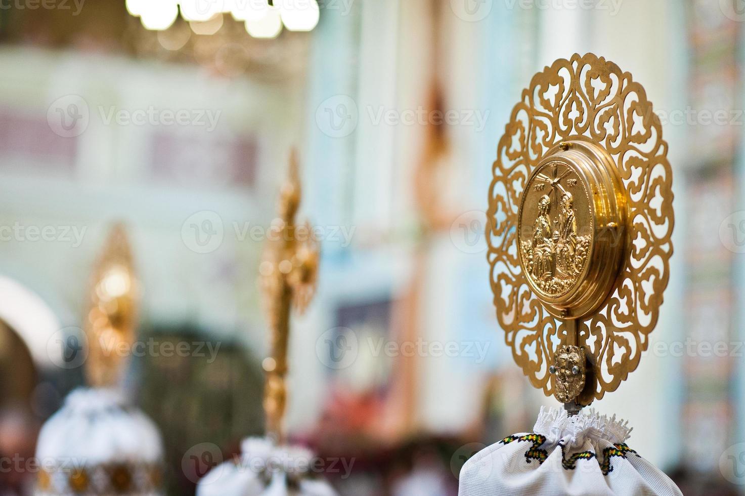 Golden cross with church element of stick throne at church photo