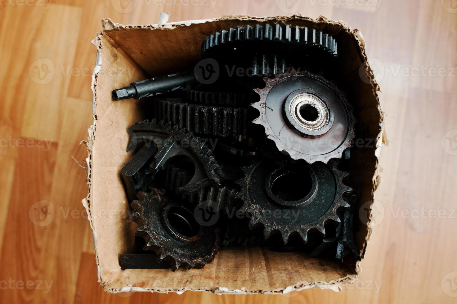 Old metal cog wheels together in box photo