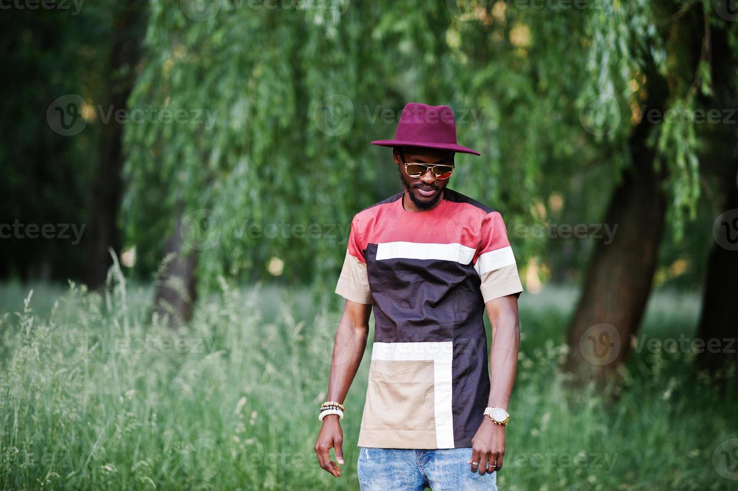 Fashionable and stylish black man with sunglasses and hat photo