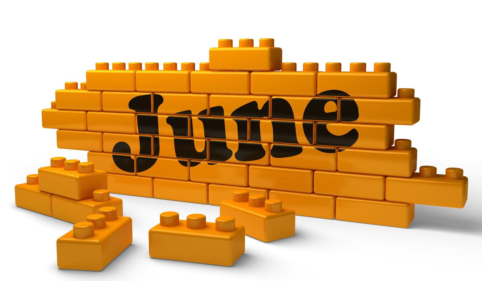 June word on yellow brick wall photo