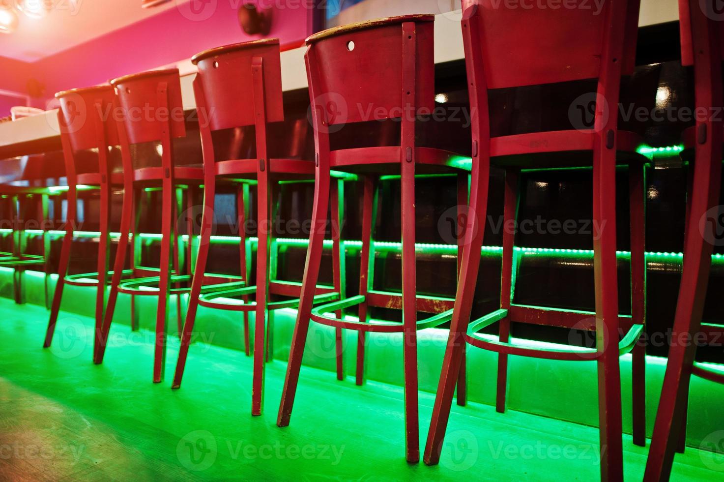 Red bar stools at diode color light photo
