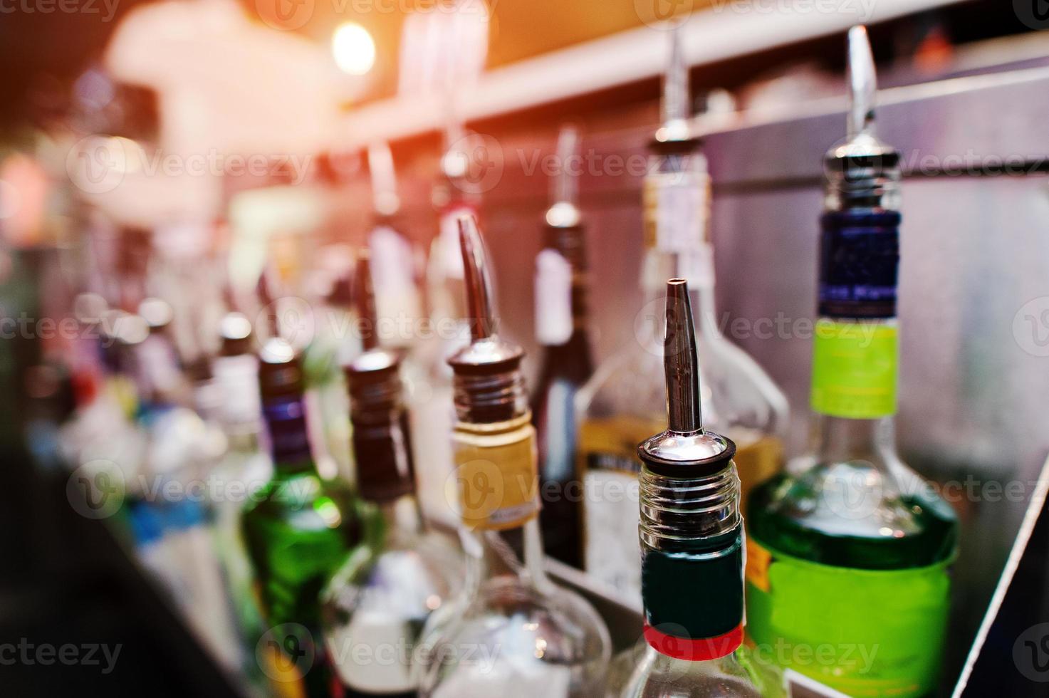 Close up bottles of alcohol and liquor at the bar photo