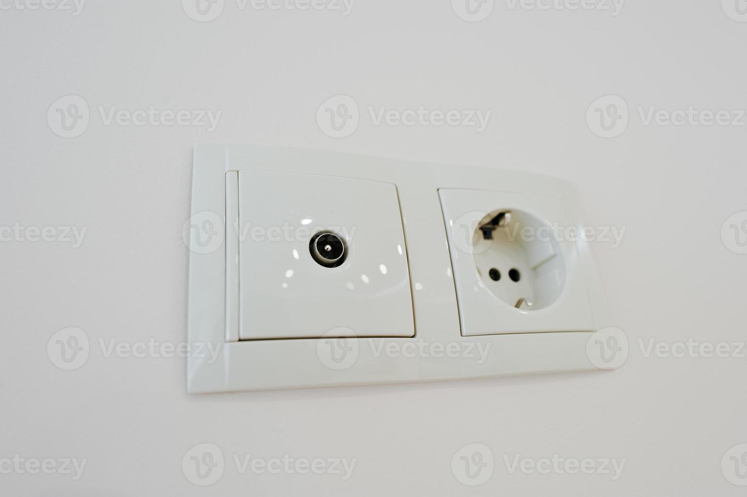 Twin electric socket with tv plug at the wall photo