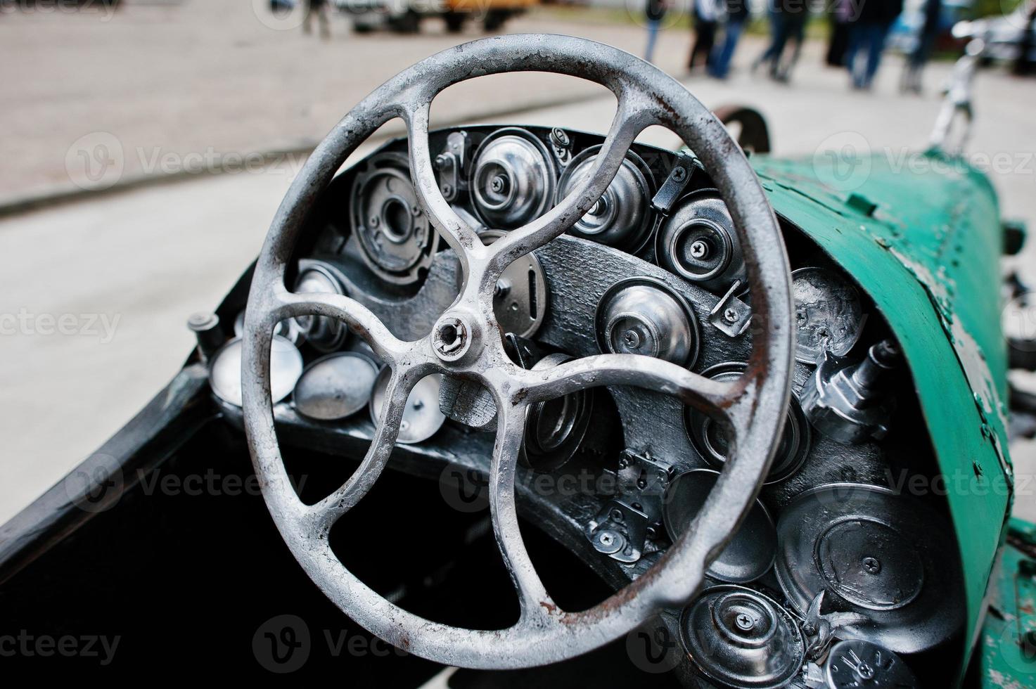 Iron handmade steering wheel at vintage sport car photo