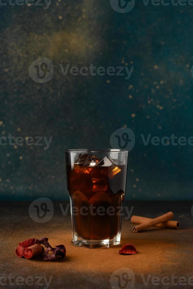 Iced coffee in a tall glass cup with cinnamon photo