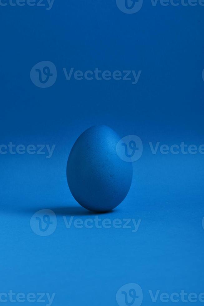 Blue egg on blue background photo