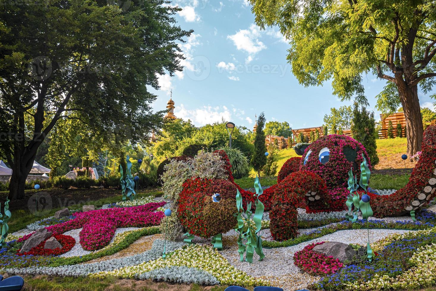 Fishes figure made of colorful flowers at annual exhibition in garden photo