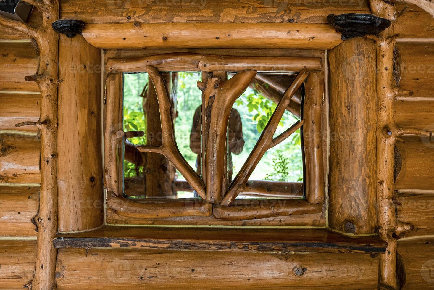 Log wall with reflection of person on glass decorative frame window photo