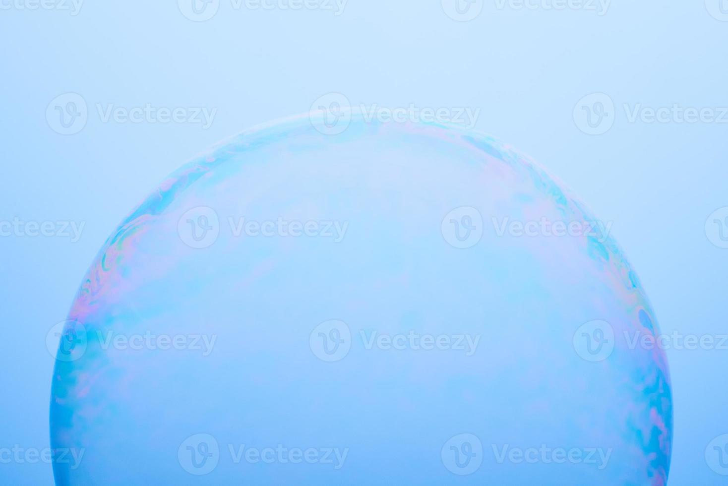 A soap bubble isolated on a blue background. Abstract photo. photo