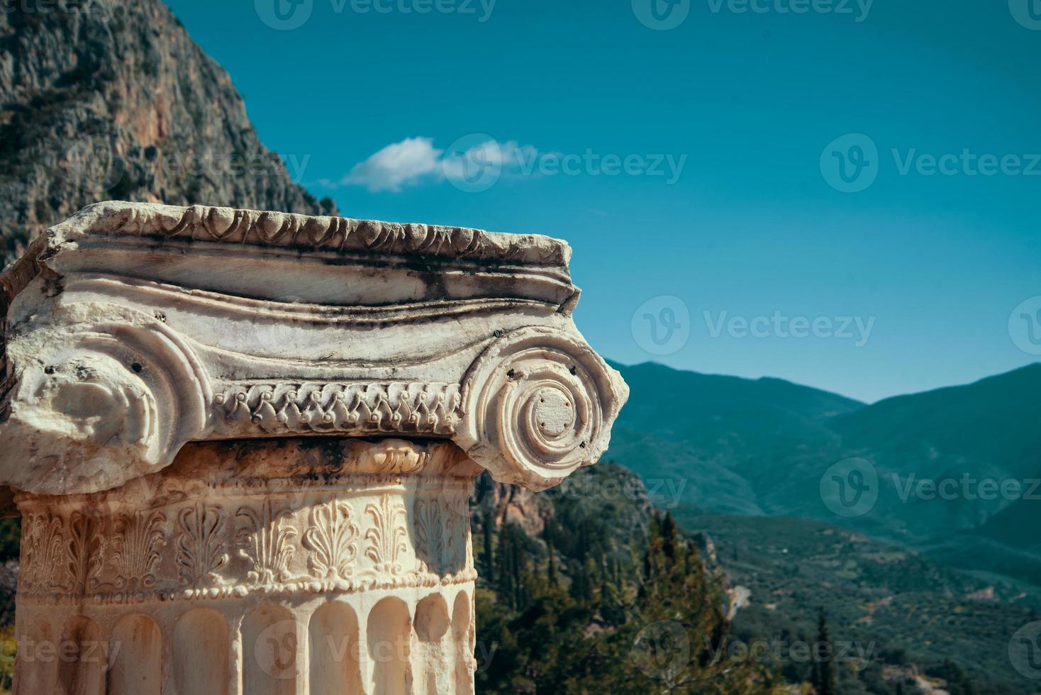 Delphi, Greece ancient marble column against the backdrop of mountains photo