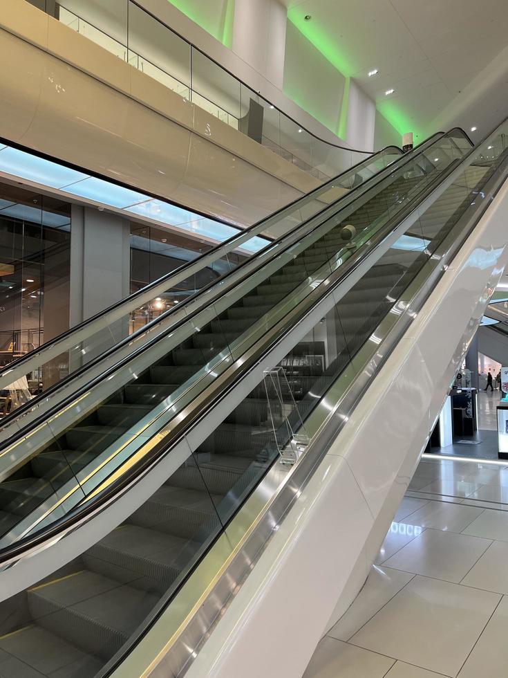 escalator in the mall. moving staircase. ascent and descent in the interior. move up or down stairs photo