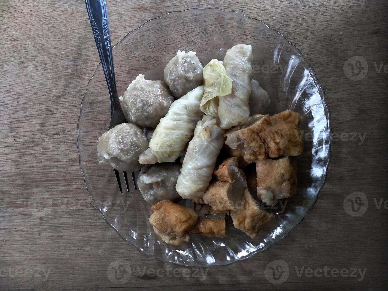 close up meatball on plate. with a wooden background. photo