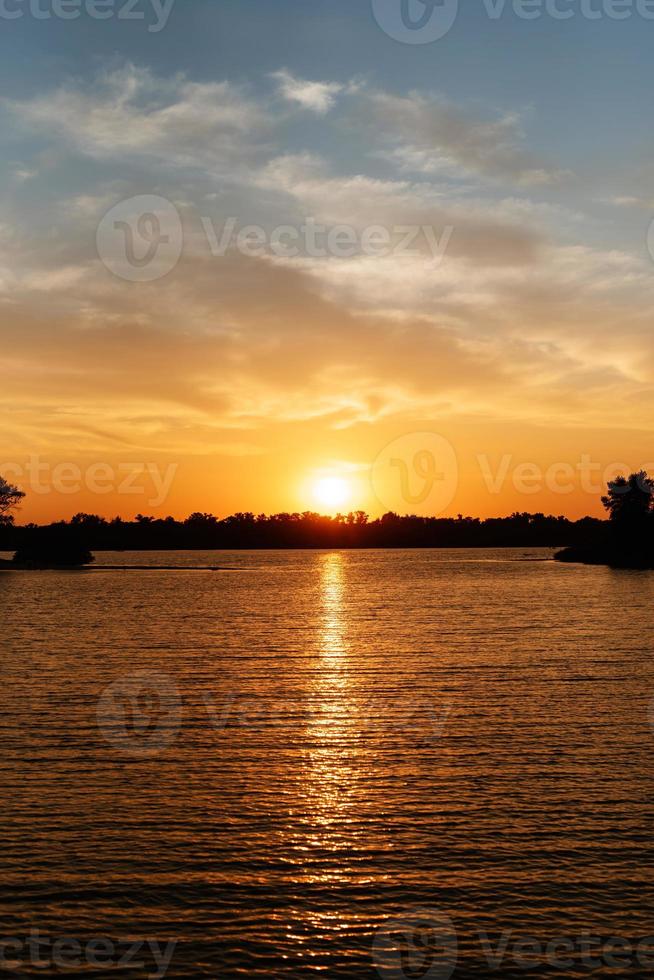 orange sunset on the river with silhouettes photo