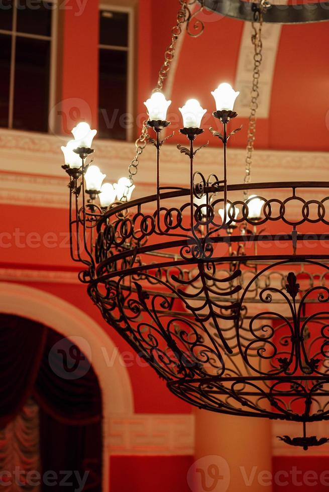 antique ceiling chandelier with lamps in red light photo