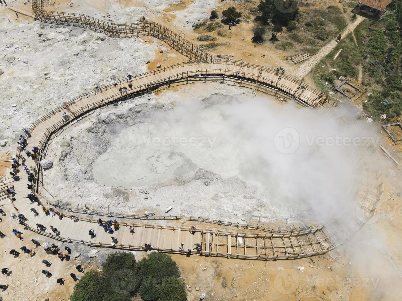 Aerial view of Sikidang crater with the background of sulfur vapor coming out of the sulfur marsh. photo