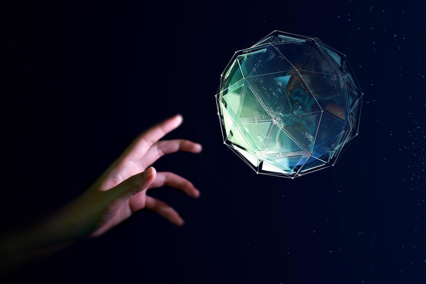 Human hand about to touch the earth globe, Earth Day concept photo