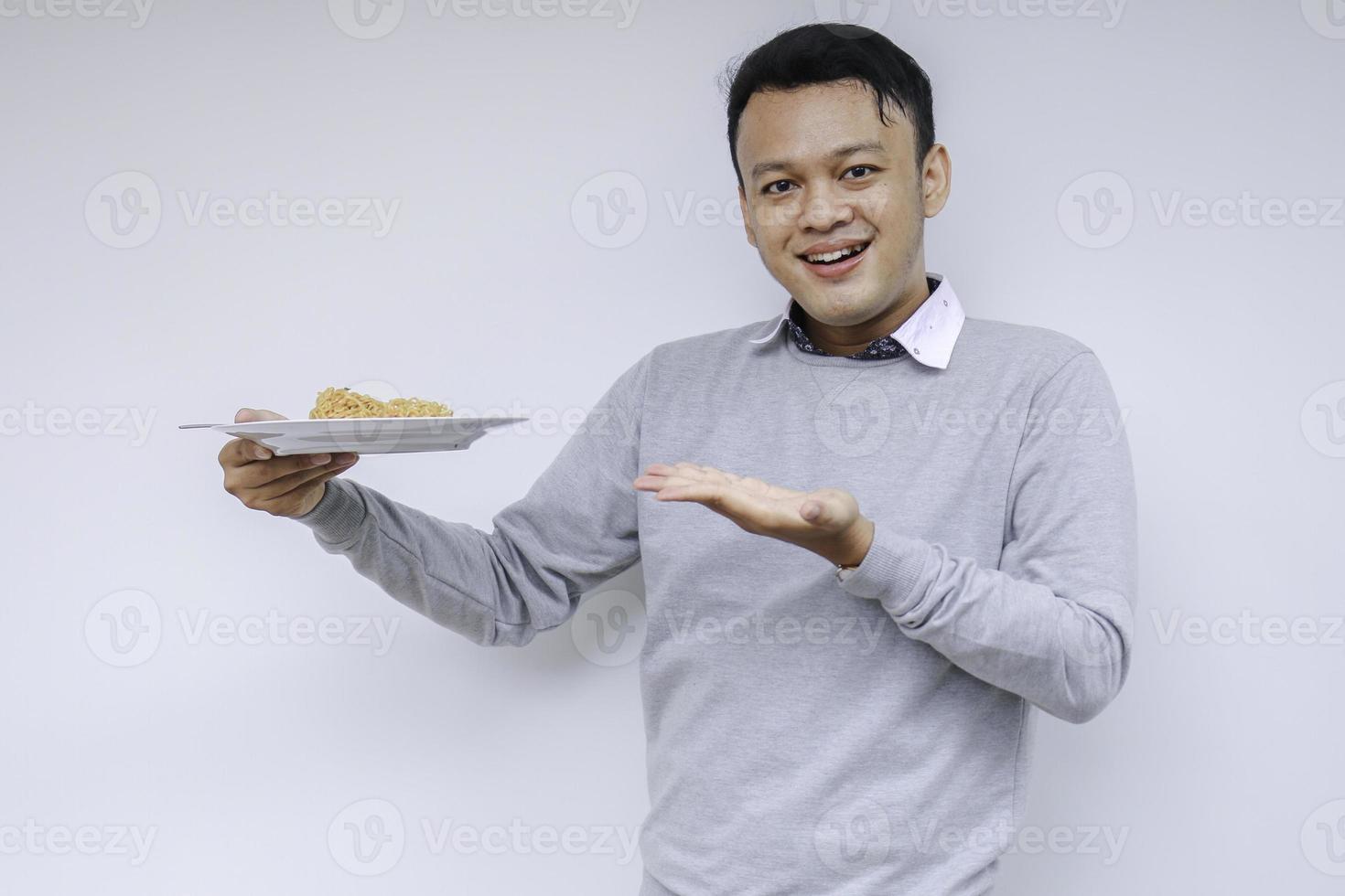 Portrait of happy Young Asian man enjoys noodles. Eating lunch concept photo