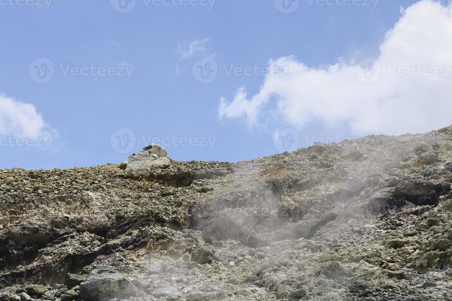 Rocky slopes in the mountains. Amazing view at the peaks which rose against the cloud sky. Path on the tops of mountains. photo