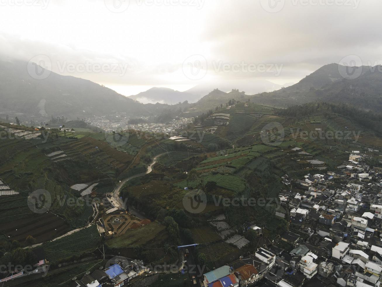 Aerial view of Dieng village at Wonosobo with mountain around it photo