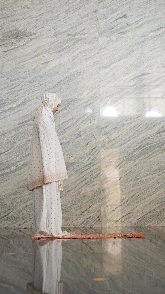 Asian Muslim women praying at the mosque photo