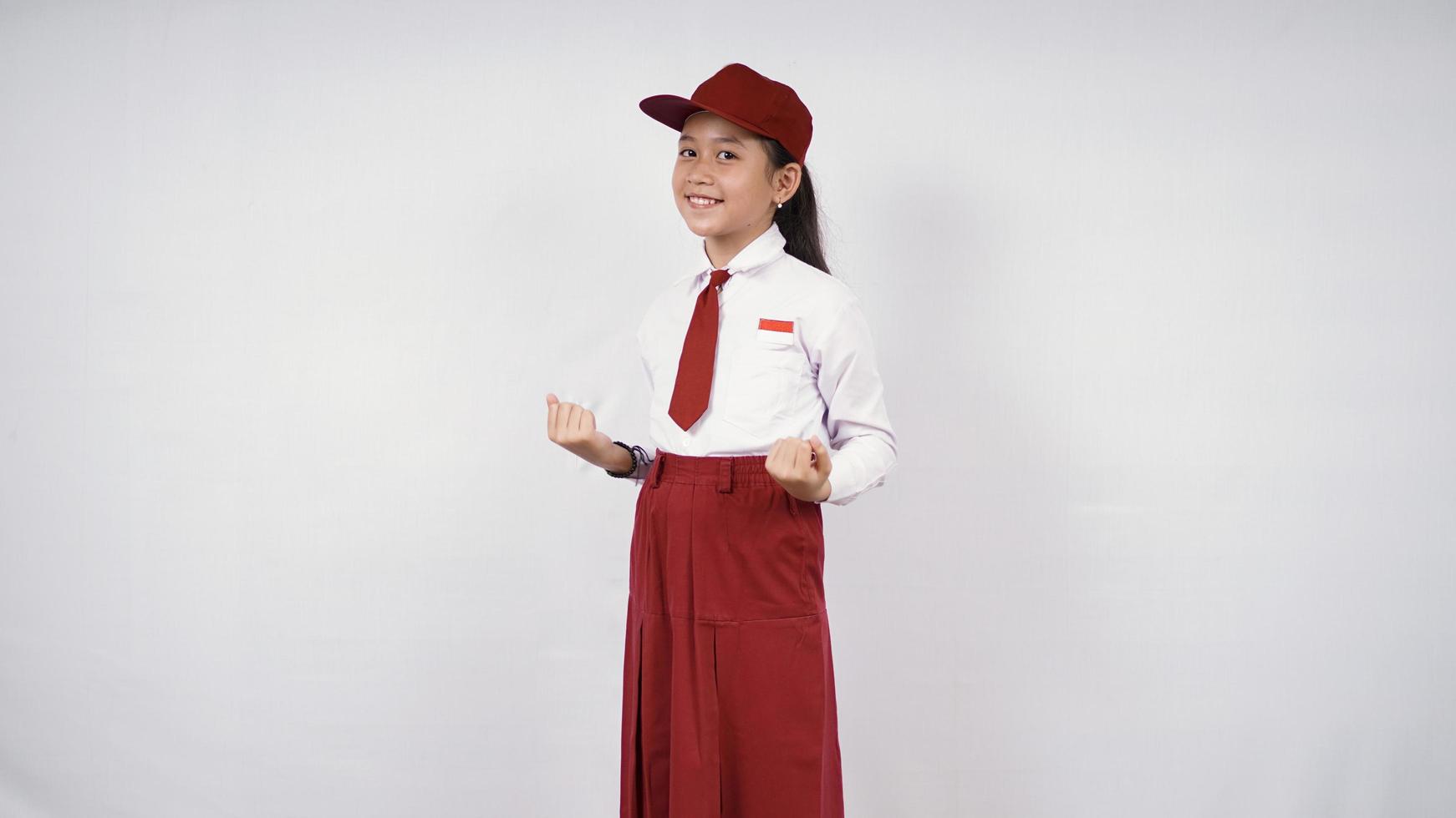 Asian elementary school girl feeling successful isolated on white background photo