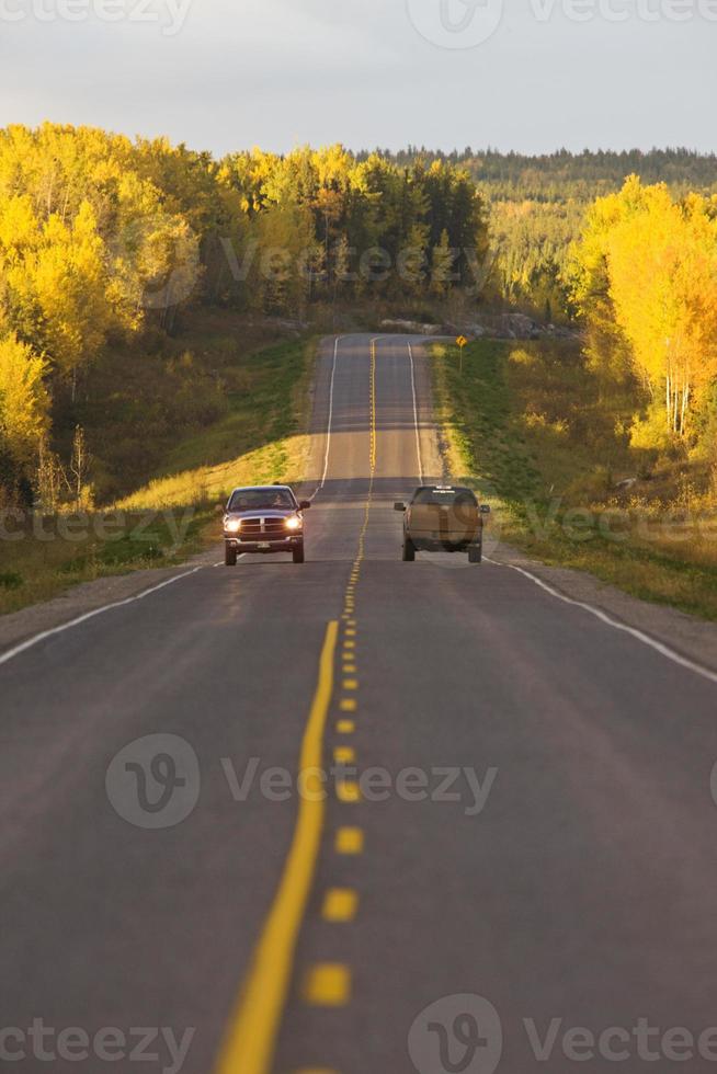 Northern Manitoba road in autumn cars photo