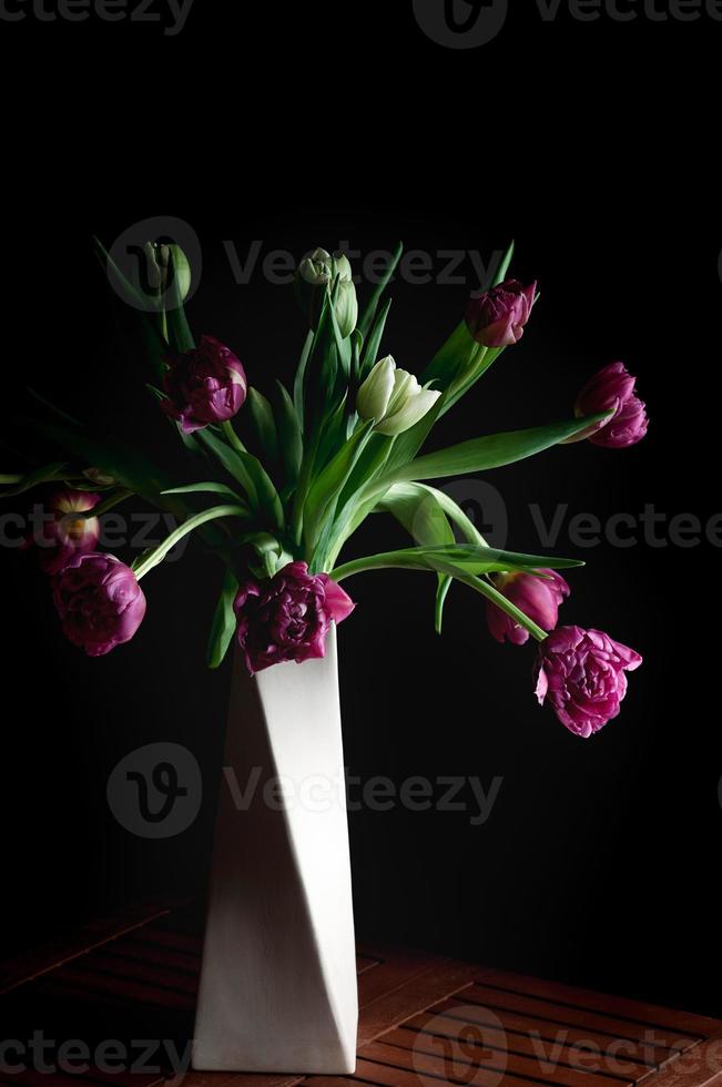 beautiful flowers in vase, low key setup, vertical image photo